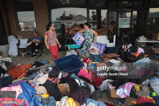 Flood victims search through donated items after torrential rains pounded Southeast Texas following Hurricane and Tropical Storm Harvey causing...