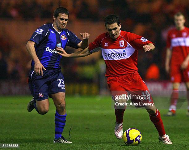 Stewart Downing of Middlesbrough holds off a challenge from David Healey of Sunderland during the Barclays Premier League match between Middlesbrough...