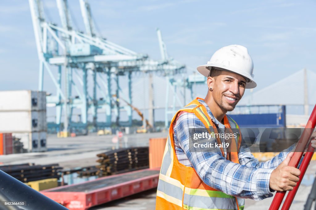 Mixed-race Hispanic man working at shipping port