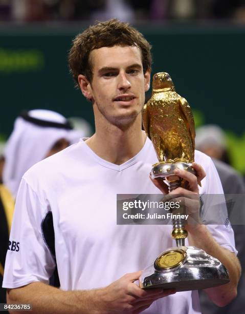 Andy Murray of Great Britain celebrates with the trophy after defeating Andy Roddick of United States in the final during the Exxon Mobil Qatar Open...