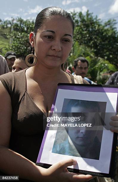 Costa Rican Arelys Vargas holds her missing brother Jose Roberto Vargas' portrait, on January 10 in San Miguel de Sarapiqui, 55 kilometers north of...