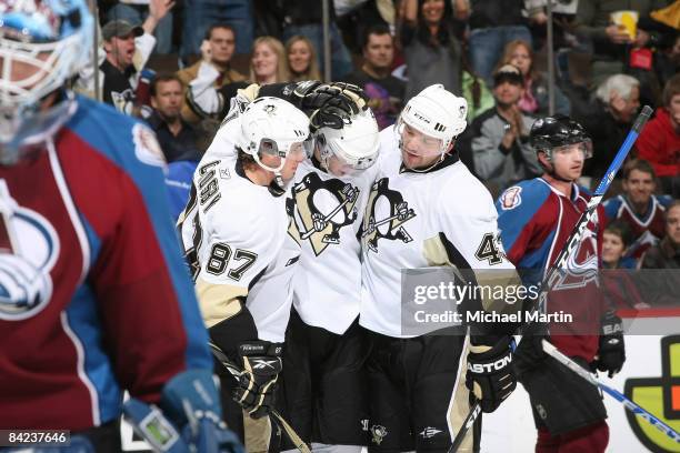 Evgeni Malkin of the Pittsburgh Penguins is congratulated by teammates Sidney Crosby and Philippe Boucher after scoring a goal against the Colorado...
