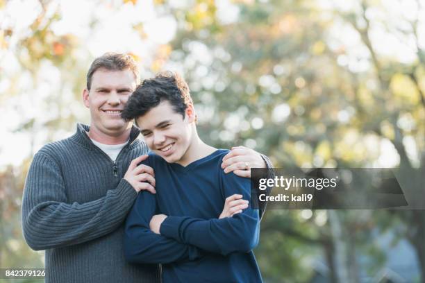 father and teenage boy standing outdoors - teen son stock pictures, royalty-free photos & images