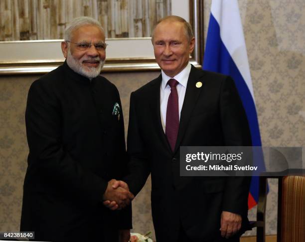 Russian President Vladimir Putin shakes hands with Indian Prime Minister Narendra Modi during their meeting in Xiamen, China, September 2017. Leaders...