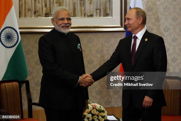 Russian President Vladimir Putin shakes hands with Indian Prime Minister Narendra Modi during their meeting in Xiamen, China, September 2017. Leaders...