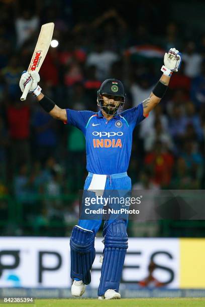 Indian cricket captain Virat Kohli celebrates after scoring 100 runs during the 5th and final One Day International cricket match between Sri Lanka...