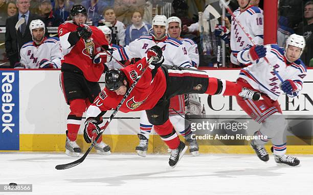 Shean Donovan of the Ottawa Senators is tripped off his feet by Colton Orr of the New York Rangers at Scotiabank Place on January 10, 2009 in Ottawa,...