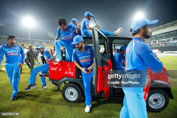 The Indian cricket captain Virat Kohli and team mates take a ride in a van after winning the ODI series against the host Sri Lanka by 5-0 after the...