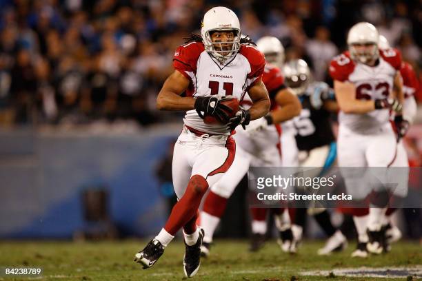 Wide receiver Larry Fitzgerald of the Arizona Cardinals runs in a first quarter touchdown against the Carolina Panthers during the NFC Divisional...