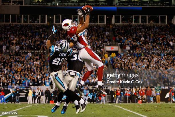 Wide receiver Larry Fitzgerald of the Arizona Cardinals catches a pass against the Ken Lucas of the Carolina Panthers during the NFC Divisional...