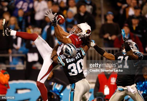 Wide receiver Larry Fitzgerald of the Arizona Cardinals catches a pass against Ken Lucas and Charles Godfrey of the Carolina Panthers during the NFC...