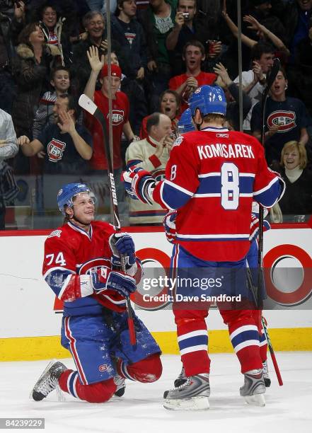 Sergei Kostitsyn of the Montreal Canadiens is all smiles as he is congratulated by teammate Mike Komisarek after he scored the game winning goal...