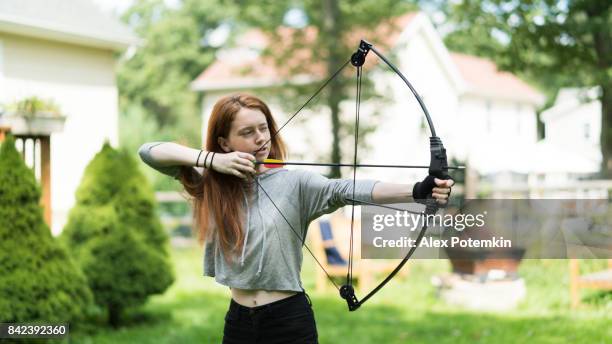 the teenager girl practicing archery - shooting at goal stock pictures, royalty-free photos & images