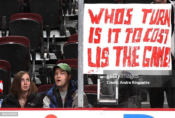Fans look at a sign posted on the glass after the Ottawa Senators lose against the New York Rangers at Scotiabank Place on January 10, 2009 in...