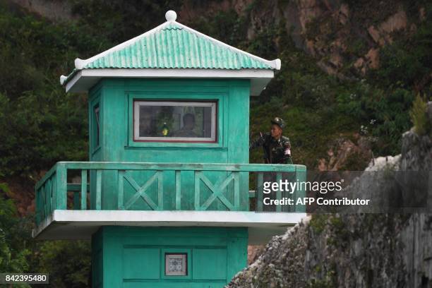 North Korean soldier stands on a guard post on the bank of the Yalu river near the North Korean town of Sinuiju, opposite the Chinese border city of...