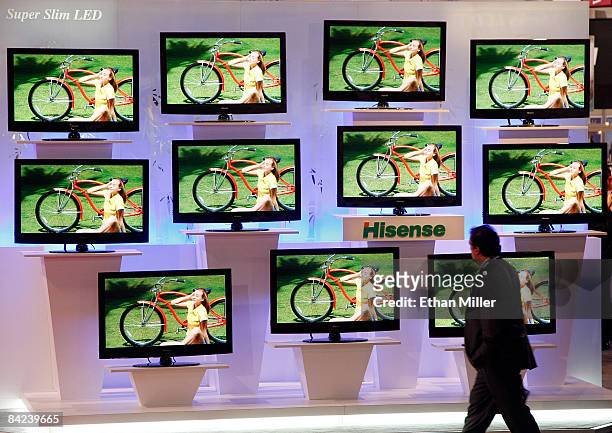 An attendee walks past Hisense super slim LED televisions at the 2009 International Consumer Electronics Show at the Las Vegas Convention Center...