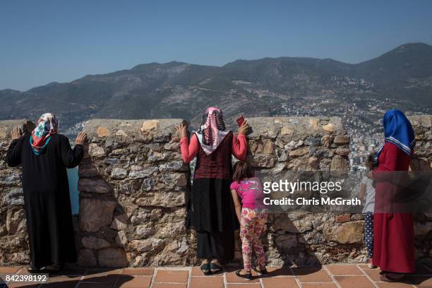 Tourists look out over Alanya from the Alanya castle on September 3, 2017 in Alanya, Turkey. Turkey's tourism industry spiraled into crisis in 2016...