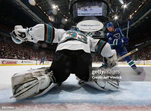 Brian Boucher of the San Jose Sharks makes a save on Mats Sundin of the Vancouver Canucks during their game at General Motors Place on January 10,...