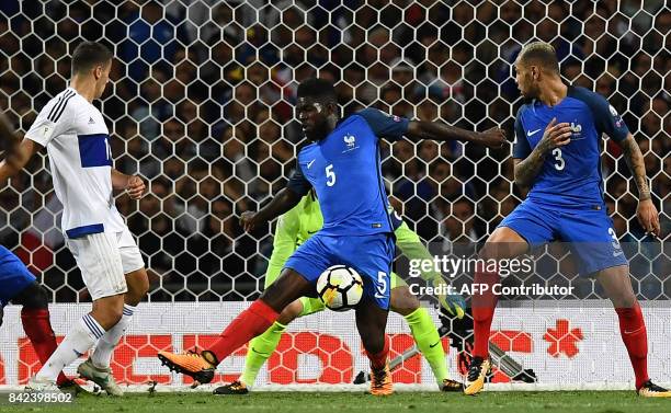 France's defender Samuel Umtiti vies with Luxembourg's midfielder Danel Sinani next to France's defender Layvin Kurzawa during the FIFA World Cup...