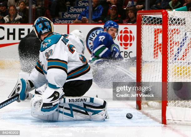 Brian Boucher of the San Jose Sharks makes a save on Daniel Sedin of the Vancouver Canucks during their game at General Motors Place on January 10,...