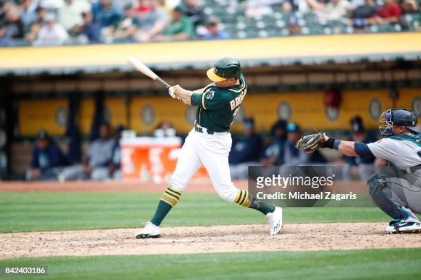 Jaycob Brugman of the Oakland Athletics bats during the game against the Seattle Mariners at the Oakland Alameda Coliseum on August 9, 2017 in...
