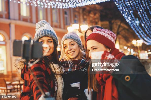 group of friends taking a jolly selfie - monopod winter stock pictures, royalty-free photos & images