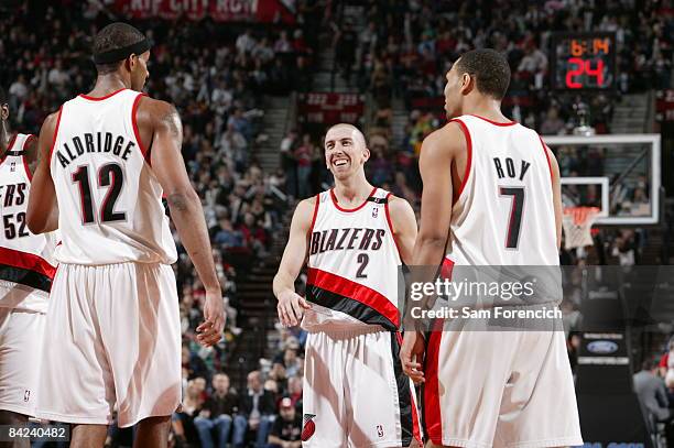 LaMarcus Aldridge, Steve Blake and Brandon Roy of the Portland Trail Blazers flash a smile during a game against the Golden State Warriors on January...