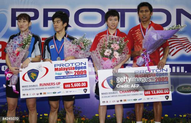 South Korea's Lee Hyu Jong and Lee Hyo Jung , and champions Indonesia's mixed doubles pair Liliyana Natsir and Nova Widianto pose on the podium after...