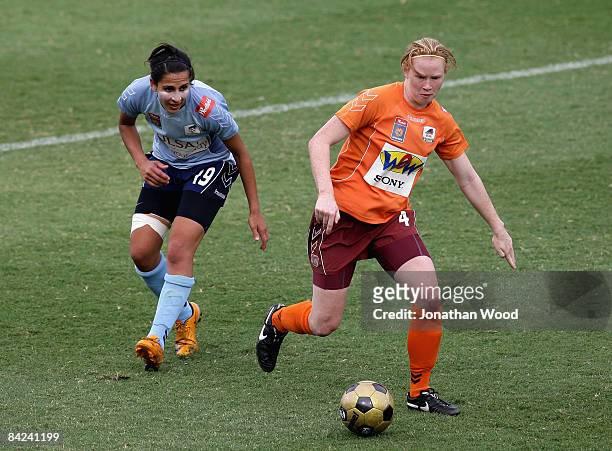 Clare Polkinghorne of the Roar gets passed Leena Khamis of Sydney FC during the W-League Semi Final match between the Queensland Roar and Sydney FC...