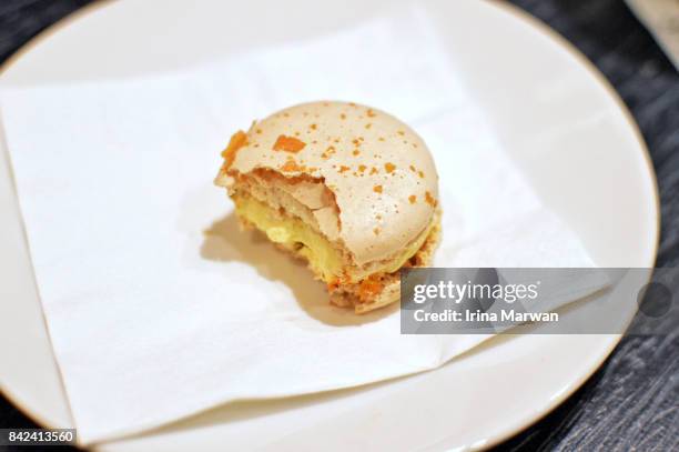 half bitten macaroon - crack filling stock pictures, royalty-free photos & images