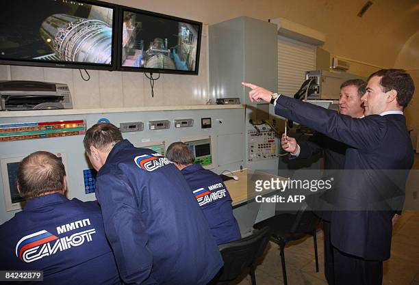 Russian President Dmitry Medvedev listens to explanations as he visits the mechanical treatment shop of the Moscow Machine-Building Plant Salyut on...