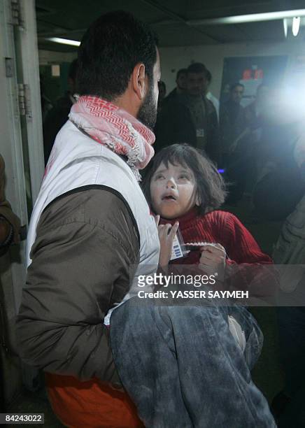 Palestinian girl wounded during Israeli strikes is carried into Shifa hospital in Gaza City on January 11, 2009. Israeli troops and Hamas fighters...