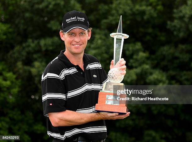 Anders Hansen of Denmark holds the trophy after his final round 66 to secure a one shot victory during the final round of the Joburg Open at Royal...