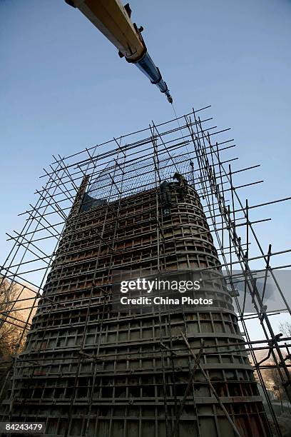 Workers build a pier of a viaduct at the construction site of second phase of the Qinghai-Tibet railway from Xining to Golmud on January 11, 2009 in...