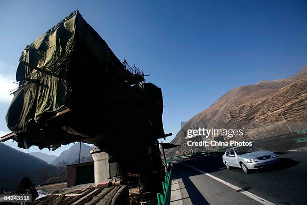 Car runs past a pier of a viaduct at the construction site of second phase of the Qinghai-Tibet railway from Xining to Golmud on January 11, 2009 in...