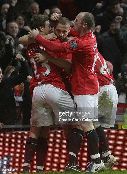 Nemanja Vidic of Manchester United celebrates with team mates Jonny Evans and Wayne Rooney after scoring their first goal during the Barclays Premier...