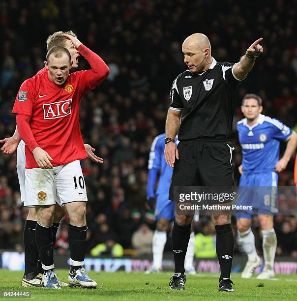 Wayne Rooney of Manchester United complains to referee Howard Webb after Cristiano Ronaldo's goal was ruled out during the Barclays Premier League...