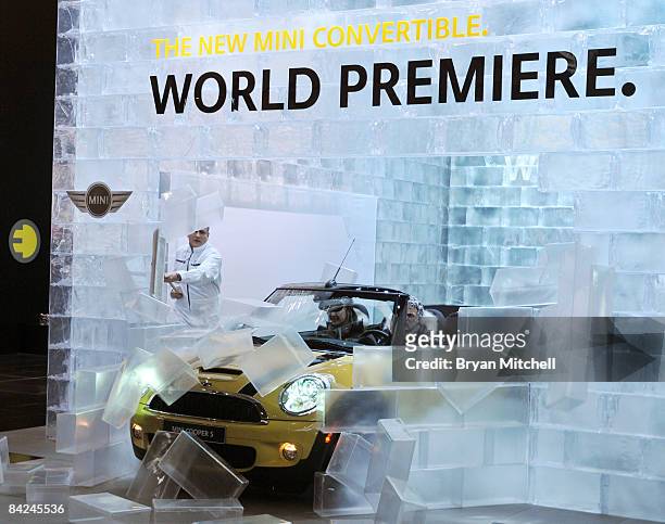 The new Mini Convertible crashes through a wall of fake ice blocks during the world premiere of the car to the world automotive media during a press...