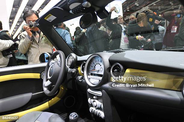 Reporters and photographers look of the interior of the new Mini Convertible during the world premiere of the car to the world automotive media...