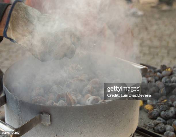 roasted chestnut in pan - eisbein stock pictures, royalty-free photos & images