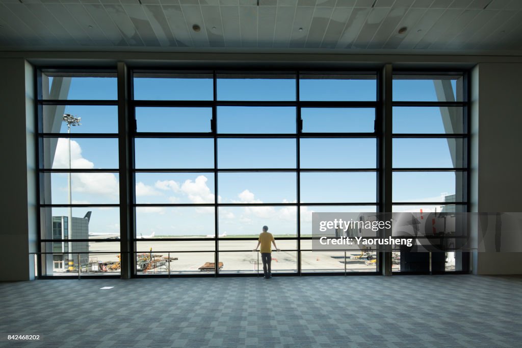 Young people look at the airplane taking off at Shagnhai PUdong international airport