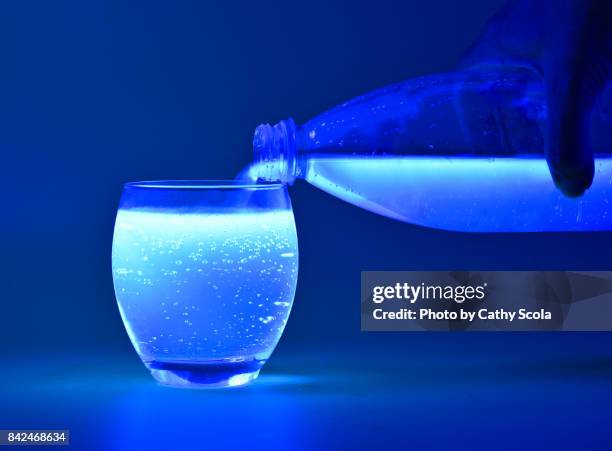 tonic water under black light - fluorescent stock pictures, royalty-free photos & images