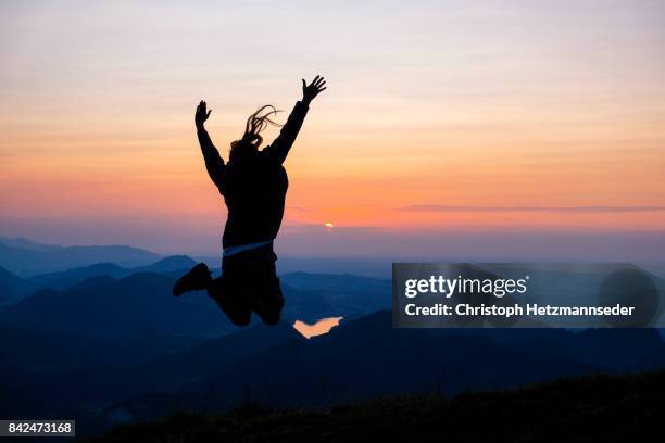 woman jumping in the mountains - upper austria stock pictures, royalty-free photos & images