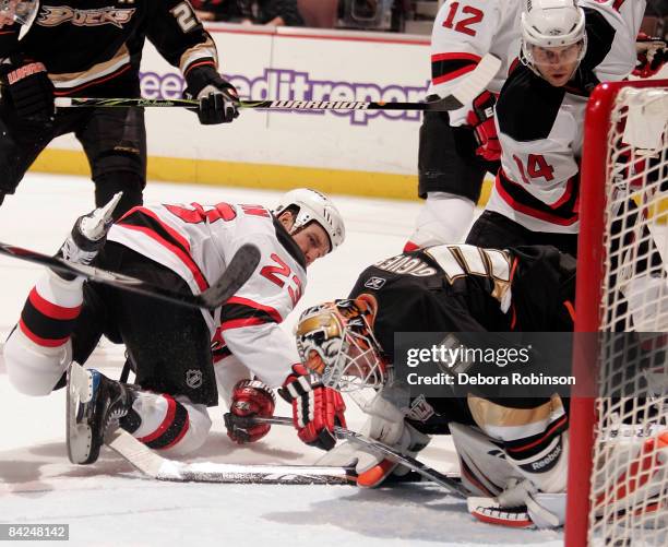 Jean-Sebastien Giguere of the Anaheim Ducks defends in the crease against David Clarkson of the New Jersey Devils during the game on January 11, 2009...