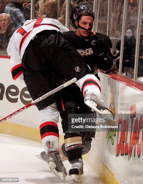 Mike Rupp of the New Jersey Devils is flipped by Ryan Getzlaf of the Anaheim Ducks during the game on January 11, 2009 at Honda Center in Anaheim,...