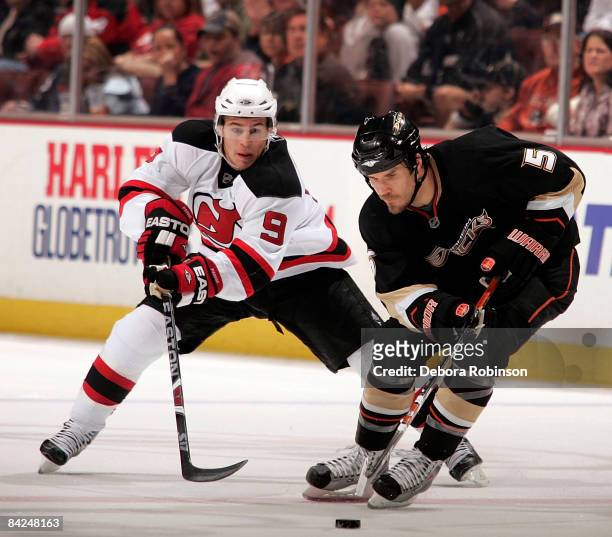 Zach Parise of the New Jersey Devils reaches in for the puck against Steve Montador of the Anaheim Ducks during the game on January 11, 2009 at Honda...