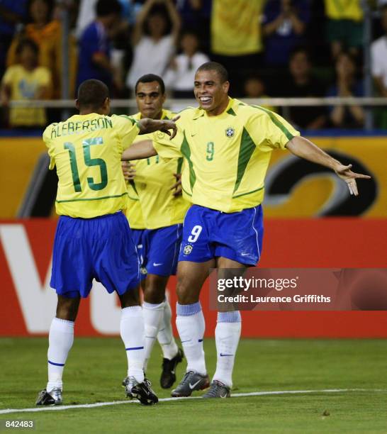 Ronaldo of Brazil celebrates his goal with team-mates Denilson and Kleberson during the FIFA World Cup Finals 2002 Second Round match between Brazil...