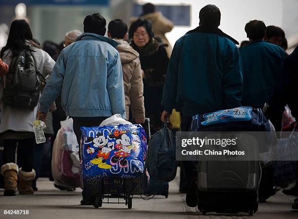 Passengers go to board trains at the Hefei Railway Station on January 11, 2009 in Hefei of Anhui Province, China. Spring Festival travel season has...