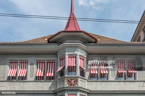 building with red-striped awnings, zurich, switzerland - awning window fotografías e imágenes de stock