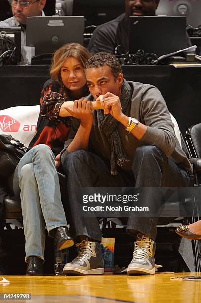 Actor Ellen Pompeo and husband Chris Ivery watch a game from courtside between the Miami Heat and the Los Angeles Lakers at Staples Center on January...
